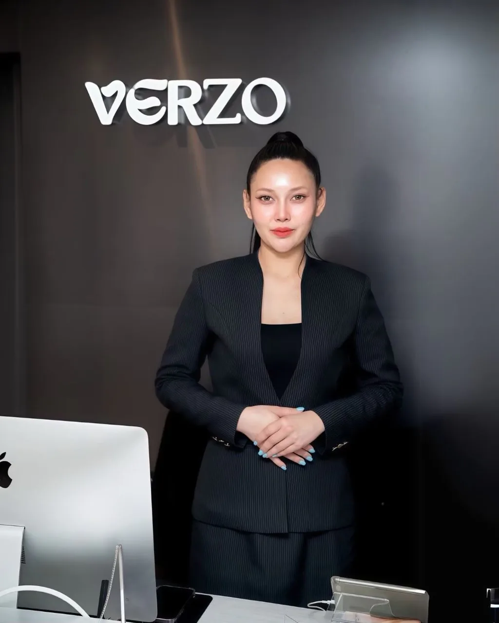 VERZO CLINIC reception team member standing behind the front desk