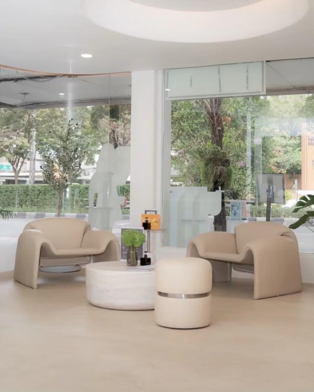 Street-facing VERZO CLINIC lounge with cream chairs and full-height windows