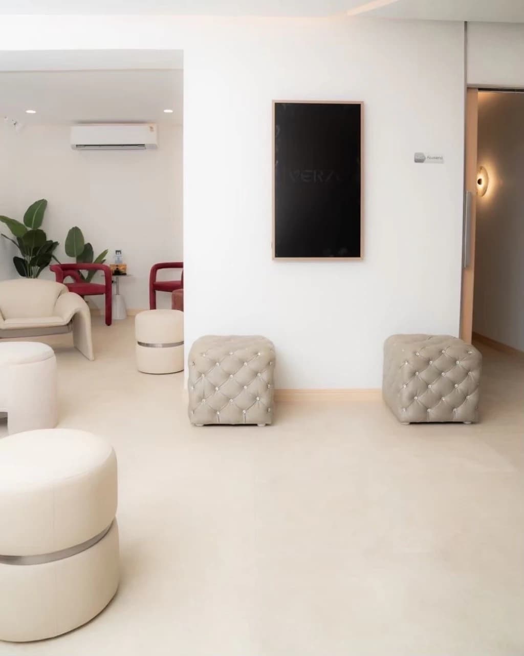 Bright VERZO CLINIC waiting area with cream seating and a corridor